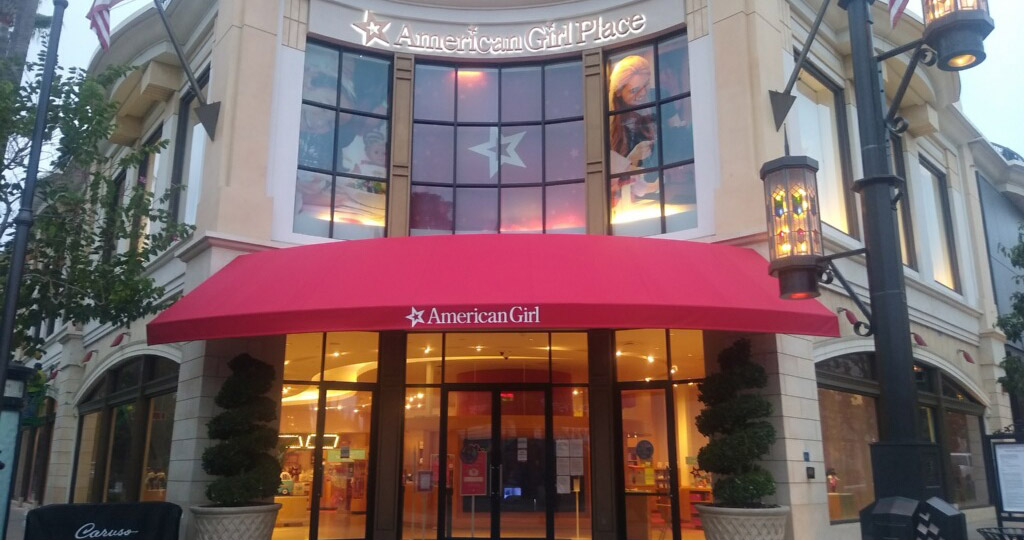 American Girl Place entrance with awning and large windows.