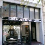 Aux Delices bakery and café storefront with BAKERY . BREAKFAST . LUNCH awning.