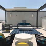 Rooftop patio with seating and built-in fireplace.