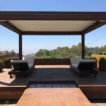 Modern pergola with flat roof and two lounge chairs.
