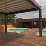 Backyard with wooden deck, pergola, pool, and hot tub.