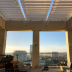 Rooftop lounge with modern seating and string lights.