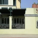 Rosies BBQ & Grillery building with sign and patio railing.