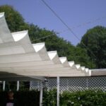 Retractable fabric shade canopy extended over patio.