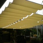 Fabric shade panels suspended above patio area.