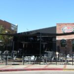 Empty tables and chairs outside Slidebar building.