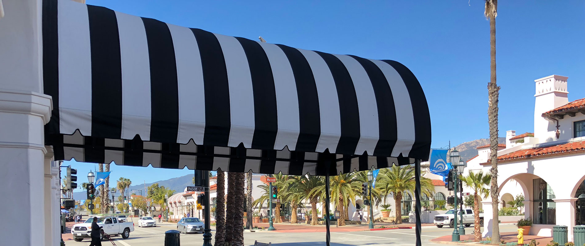 Striped awning over sidewalk.