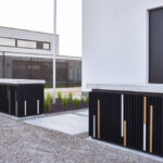 Two outdoor cabinets with vertical slats and colored accents.