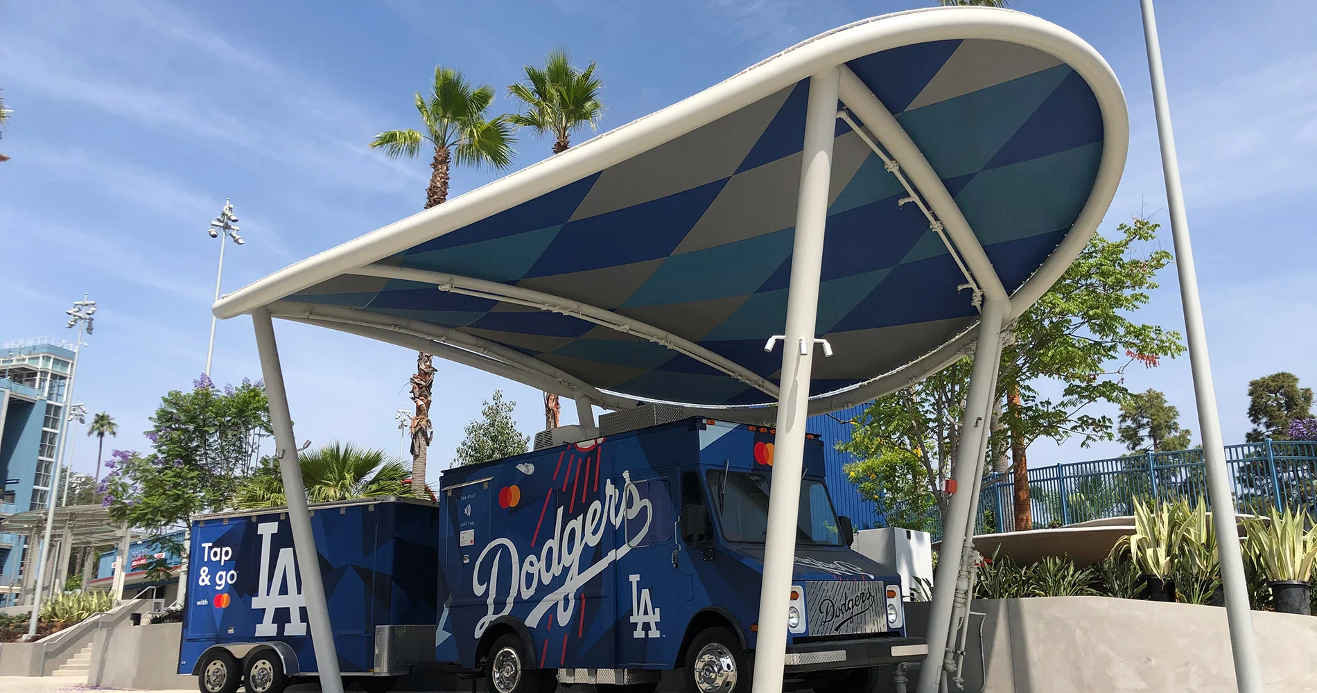 Los Angeles Dodgers food truck and trailer under modern canopy.